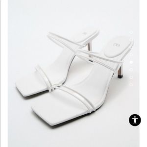 High heel white sandals with thin vinyl straps. Squared toe. Comfortable classy